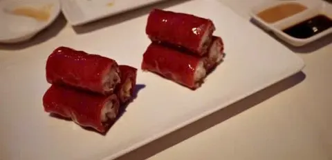 Hai đĩa cuốn vỏ màu đỏ cắt khúc, bên trong có lớp nhân giòn (ảnh An gửi)